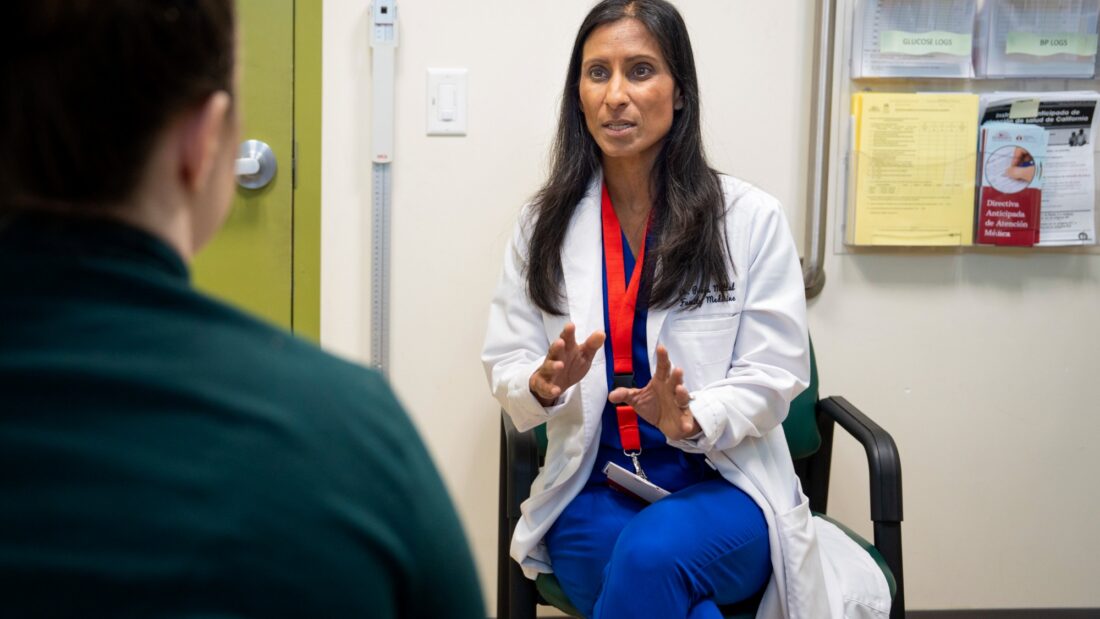 reducing disparities Medi-Cal plans. A doctor meets with a patient in an exam room.