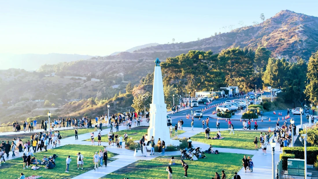 Crowd of people enjoying a sunny day at Griffith Park in Los Angeles, CA.